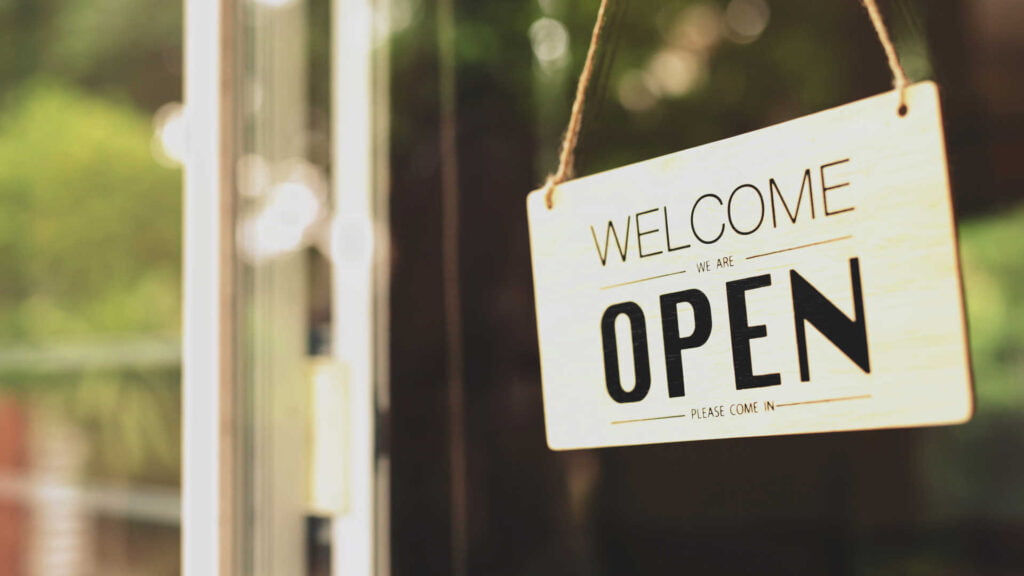 Small business with 'open' door sign hanging